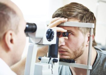 Ophthalmology concept. Male patient under eye vision examination in eyesight ophthalmological correction clinic