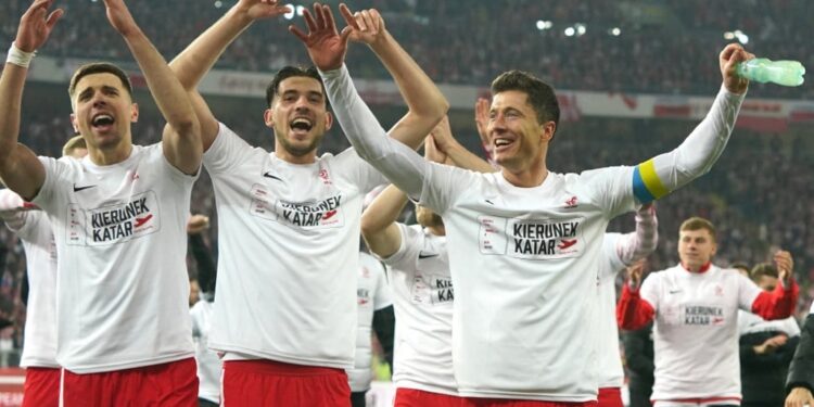 Poland's players react after winning the FIFA World Cup Qatar 2022 qualifying final first Leg football match Poland v Sweden at the Slaski Stadium in Chorzow, Poland on March 29, 2022. (Photo by JANEK SKARZYNSKI / AFP)