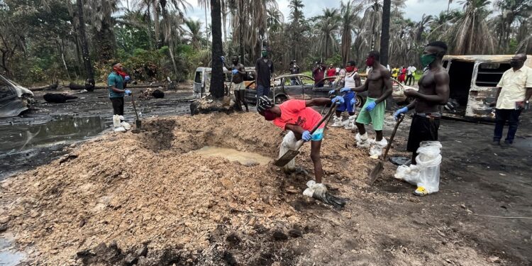 A person digs a grave for the mass burial of victims of the explosion at the illegal bunkering site in Imo state, Nigeria April 26, 2022. REUTERS/Tife Owolabi