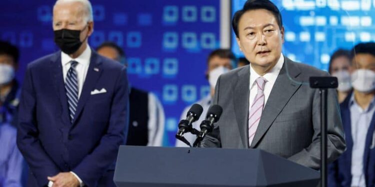 U.S. President Joe Biden looks on as South Korean President Yoon Suk-yeol delivers remarks during a visit to a semiconductor factory at the Samsung Electronics Pyeongtaek Campus in Pyeongtaek, South Korea, May 20, 2022. REUTERS/Jonathan Ernst