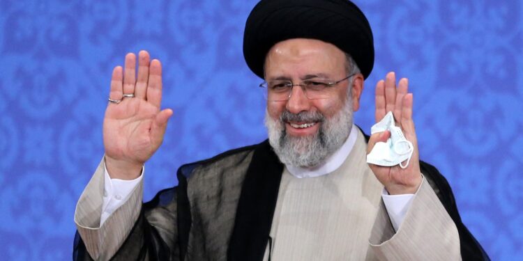 Iran's President-elect Ebrahim Raisi smiles as he greets media representatives during his first press conference in the Islamic republic's capital Tehran, on June 21, 2021. - Iran's new president hailed what he called a 'massive' voter turnout during last week's presidential election. The ultraconservative cleric was declared the winner of the election on the weekend, replacing moderate Hassan Rouhani. (Photo by ATTA KENARE / AFP)