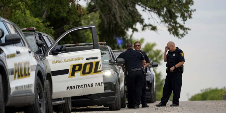 Police protect the scene where officials say dozens of people have been found dead and multiple others were taken to hospitals with heat-related illnesses after a semitrailer containing suspected migrants was found, Tuesday, June 28, 2022, in San Antonio. (AP Photo/Eric Gay)