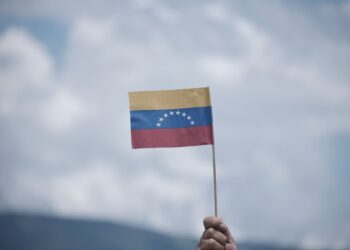 An attendee holds a Venezuelan flag during the commercial border reopening between Venezuela and Colombia in Cucuta, Norte de Santander department, Colombia, on Monday, Sept. 26, 2022. Colombia and Venezuela fully re-opened their border on Monday, potentially reactivating billions of dollars in trade that dried up during years of diplomatic tension. Photographer: Ferley Ospina/Bloomberg