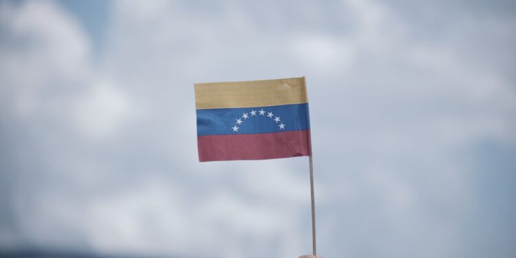 An attendee holds a Venezuelan flag during the commercial border reopening between Venezuela and Colombia in Cucuta, Norte de Santander department, Colombia, on Monday, Sept. 26, 2022. Colombia and Venezuela fully re-opened their border on Monday, potentially reactivating billions of dollars in trade that dried up during years of diplomatic tension. Photographer: Ferley Ospina/Bloomberg