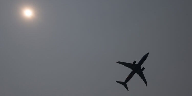 A Southwest Boeing 737 airplane takes off into a smoke haze from Ronald Reagan Washington National Airport in Arlington, Virginia, June 8, 2023, as smoke from wildfires in Canada blankets the area. Smoke from Canadian wildfires have shrouded the US East Coast in a record-breaking smog, forcing cities to issue air pollution warnings and thousands of Canadians to evacuate their homes. The devastating fires have displaced more than 20,000 people and scorched about 3.8 million hectares (9,390,005 acres) of land. Prime Minister Justin Trudeau described this wildfire season as the country's worst ever. (Photo by SAUL LOEB / AFP)