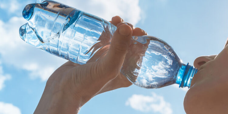 Woman drinking water after her workout.