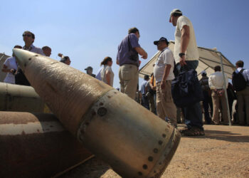 FILE - Activists and international delegations stand next to cluster bomb units, during a visit to a Lebanese military base at the opening of the Second Meeting of States Parties to the Convention on Cluster Munitions, in the southern town of Nabatiyeh, Lebanon, Sept. 12, 2011. The Biden administration has decided to provide cluster munitions to Ukraine and is expected to announce on Friday, July 6, 2023, that the Pentagon will send thousands as part of the latest military aid package for the war effort against Russia, according to people familiar with the decision. (AP Photo/Mohammed Zaatari, File)