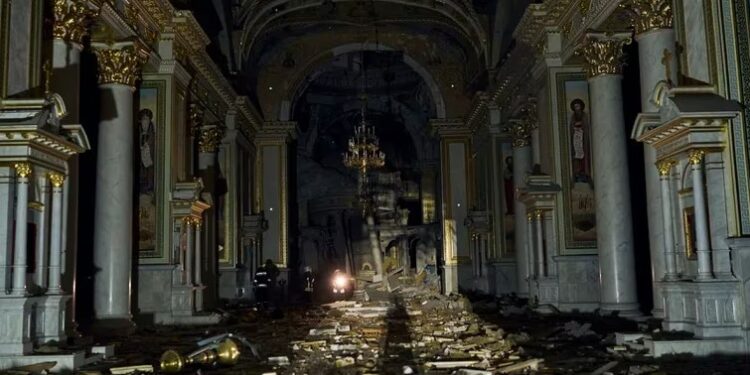 Bomberos caminan dentro de la catedral de Transfiguración de Odesa, muy dañada por un ataque de misiles en Odesa (AP Foto/Libkos)