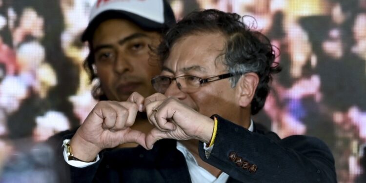 (FILES) Colombian presidential candidate for the Historic Pact coalition, Gustavo Petro, makes the shape of a heart, accompanied by his son Nicolas Petro, as he celebrates at the party headquarters in Bogota on May 29, 2022, on election day. Colombian President Gustavo Petro said on July 29, 2023, that his son Nicolas had been arrested on charges of money laundering and illicit enrichment in a scandal linked to Petro's election campaign. (Photo by YURI CORTEZ / AFP)