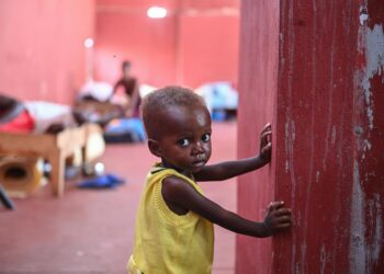 Nineteen-month-old David stands inside the Fontaine Hospital Center in the Cite Soleil slum in Port-au-Prince on August 4, 2023. In Cite Soleil, the largest slum in the gang-infested Haitian capital, the early days of August have brought a grim flow of skeletally malnourished children to the Fontaine Hospital Center. 
The community clinic, a reassuring presence in this poorest corner of Port-au-Prince for more than 30 years, offers rare respite to inhabitants who now face daily threats from the armed groups controlling much of the city. (Photo by Richard PIERRIN / AFP)