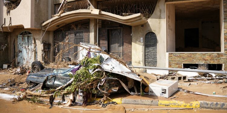 This handout picture provided by the office of Libya's Benghazi-based interim prime minister on September 11, 2023 shows a view of a destroyed vehicle by damaged buildings in the eastern city of Derna, about 290 kilometres east of Benghazi, in the wake of the Mediterranean storm "Daniel". At least 150 people were killed when freak floods hit eastern Libya, officials said on September 11, after the storm's torrential rains battered Turkey, Bulgaria, and Greece. (Photo by The Press Office of Libyan Prime Minister / AFP) / === RESTRICTED TO EDITORIAL USE - MANDATORY CREDIT "AFP PHOTO / HO /MEDIA OFFICE OF LIBYAN PRIME MINISTER (BENGHAZI)" - NO MARKETING NO ADVERTISING CAMPAIGNS - DISTRIBUTED AS A SERVICE TO CLIENTS ===