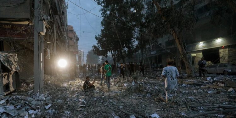 Gaza City (---), 07/10/2023.- Palestinians inspect the destroyed surrounding of the Palestine Tower after Israeli warplanes targeted it in Gaza City, 07 October 2023. Rocket barrages were launched from the Gaza Strip early 07 October in a surprise attack on Israel claimed by the Islamist movement Hamas. In a televised statement, the Israeli prime minister said the country is at war. EFE/EPA/MOHAMMED SABER