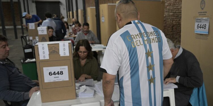 A man wearing an Argentina national football team jersey votes at a polling station in Buenos Aires during the Argentine presidential election on October 22, 2023. Argentines head to the polls gripped by anxiety and with one thing in mind: to escape an economic quagmire that has seen annual inflation hit almost 140 percent. (Photo by JUAN MABROMATA / AFP)
