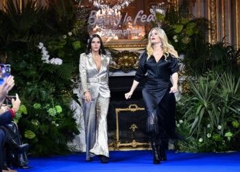 Colombian actress Natalia Ramirez (L) and Lorna Cepeda (R) present creations during a show launching the 'Hugo Lombardi Collection', a main protagonist in the Latin American telenovela 'Ugly Betty' or 'Betty, la fea' an Amazon Prime show, on the sidelines of Paris Fashion Week, at the Shangri-la in Paris on February 27, 2024. The launch of the Hugo Lombardi collection will feature select pieces by the real designer, Andres Otalora, the Colombian ready-to-wear designer, who has specialized for more than two decades in creating designs on the international scene and in the fashion weeks in New York and Paris. (Photo by Miguel MEDINA / AFP)