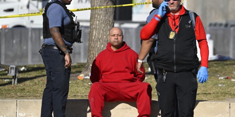 A person is detained by police near the Kansas City Chiefs' Super Bowl LVIII victory parade on February 14, 2024, in Kansas City, Missouri. Shots were reportedly fired during the parade, according to police. (Photo by ANDREW CABALLERO-REYNOLDS / AFP)