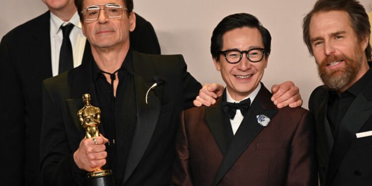 Actors Tim Robbins (L), Ke Huy Quan (2R) and Sam Rockwell (R) pose with US actor Robert Downey Jr. winner of the Oscar for Best Actor in a Supporting Role for "Oppenheimer" during the 96th Annual Academy Awards at the Dolby Theatre in Hollywood, California on March 10, 2024. (Photo by Robyn BECK / AFP)