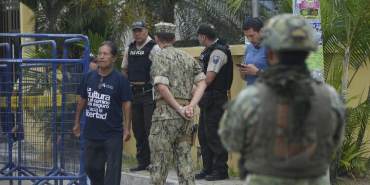 Security forces guard a polling station during a referendum on tougher measures against organized crime in Olon, Santa Elena province, Ecuador, on April 21, 2024. Ecuadorans began voting Sunday in a referendum on proposed tougher measures to fight gang-related crime. The once-peaceful South American country has been grappling with a shocking rise in violence that has seen two mayors killed this week. (Photo by Gerardo MENOSCAL / AFP)