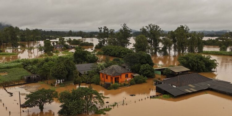 Aerial view shows a flooded area of Capela de Santana, Rio Grande do Sul state, Brazil, on May 2, 2024. . Brazilian President Luiz Inacio Lula da Silva on Thursday visited the country's south where floods and mudslides caused by torrential rains have killed 13 people, with the toll likely to rise. Authorities in Rio Grande do Sul have declared a state of emergency, as rescuers continue to search for some 21 people reported missing among the ruins of collapsed homes, bridges and roads. (Photo by CARLOS FABAL / AFP)