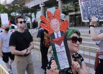 Pro-Palestinian demonstrators protest as US President Joe Biden attends the NAACP Freedom Fund dinner in Detroit, Michigan on May 19, 2024. US President Joe Biden called May 19, 2024 for an immediate ceasefire in Gaza and said he was working on a "lasting, durable peace" that would include the creation of a Palestinian state. Speaking at a graduation ceremony at the former university of civil rights icon Martin Luther King, Jr, Biden said he was pushing for a regional peace deal "to get a two-state solution, the only solution." (Photo by JEFF KOWALSKY / AFP)