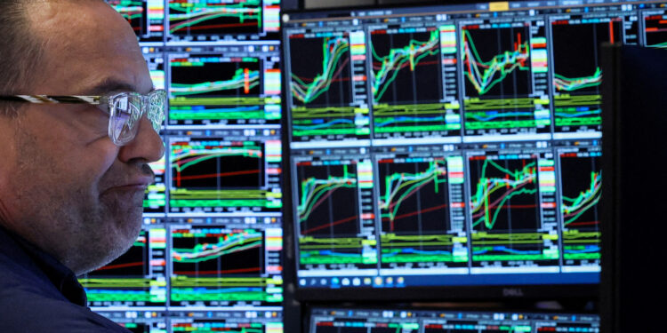 FILE PHOTO: A specialist trader works at his post on the floor at the New York Stock Exchange (NYSE) in New York City, U.S., June 3, 2024.  REUTERS/Brendan McDermid/File Photo