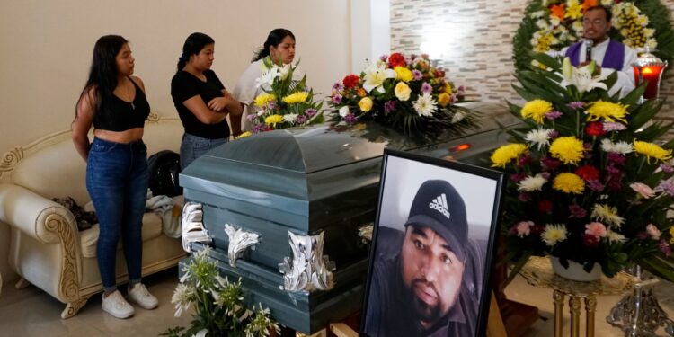 Family and friends of journalist Victor Jimenez, who disappeared in 2020, mourn his death during a mass after his remains were found in a well that was converted into a mass grave and transported by his relatives to Celaya, Guanajuato State, Mexico, for his funeral on June 12, 2024. (Photo by Mario ARMAS / AFP)