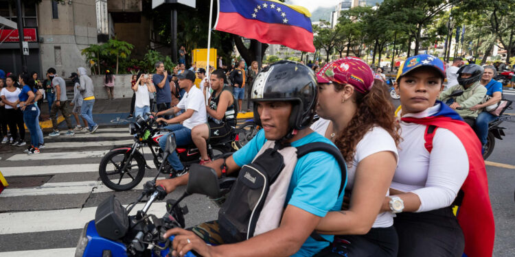 AME6309. CARACAS (VENEZUELA), 29/07/2024.- Personas de motocicletas participan en una protesta por los resultados de las elecciones presidenciales este lunes, en Caracas (Venezuela). Cientos de personas se manifiestan en Caracas luego de que el Consejo Nacional Electoral (CNE) proclamara a Nicolás Maduro como presidente reelecto de Venezuela, tras los comicios celebrados este 28 de julio. EFE/ Ronald Peña