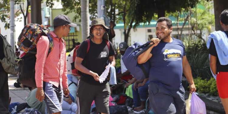 MEX4152. TAPACHULA (MÉXICO), 22/07/2024.- Migrantes caminan en una plaza pública este lunes en la ciudad de Tapachula, en el estado de Chiapas (México). Activistas mexicanos y migrantes que viajan en la caravana más numerosa de los últimos meses señalaron que la renuncia a la carrera presidencial de Estados Unidos de Joe Biden, les causa incertidumbre y preocupación pues no saben las medidas migratorias que proponga el reemplazo del presidente estadounidense. EFE/ Juan Manuel Blanco