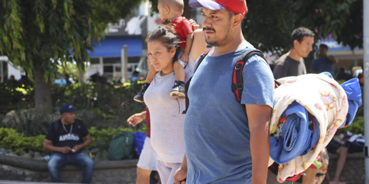 MEX4152. TAPACHULA (MÉXICO), 22/07/2024.- Migrantes caminan en una plaza pública este lunes en la ciudad de Tapachula, en el estado de Chiapas (México). Activistas mexicanos y migrantes que viajan en la caravana más numerosa de los últimos meses señalaron que la renuncia a la carrera presidencial de Estados Unidos de Joe Biden, les causa incertidumbre y preocupación pues no saben las medidas migratorias que proponga el reemplazo del presidente estadounidense. EFE/ Juan Manuel Blanco