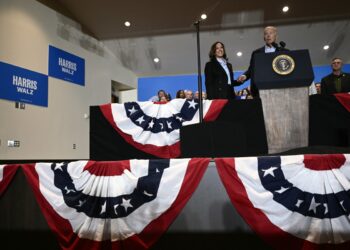 US Vice President and Democratic presidential candidate Kamala Harris (L) holds hands with US President Joe Biden as he speaks during a campaign rally at the International Brotherhood of Electrical Workers (IBEW) Local 5 in Pittsburgh, Pennsylvania, on September 2, 2024. (Photo by Brendan SMIALOWSKI / AFP)