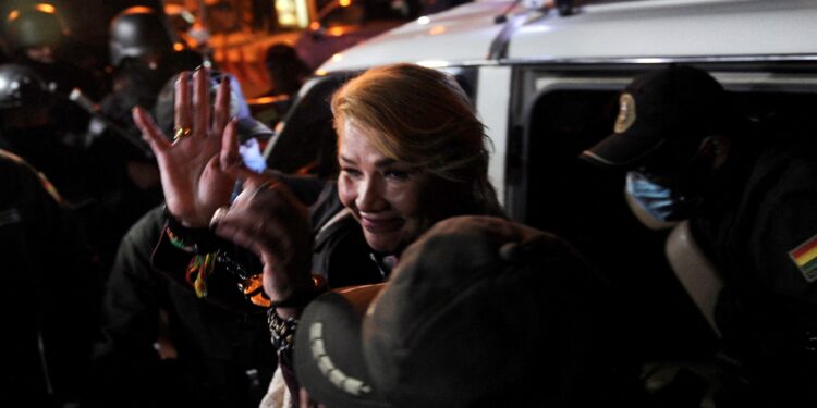 Former Bolivian interim President Jeanine Añez is escorted by police as she enters the Miraflores women's prison in La Paz on October 17, 2024. A court in La Paz rejected Thursday to prosecute former president Jeanine Áñez for allegedly having planned a coup d'état against Evo Morales in 2019, announced her lawyer Luis Guillén, at the end of the hearing for the case. (Photo by JORGE BERNAL / AFP)