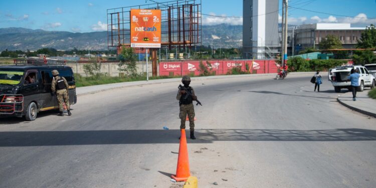 Police officers patrol near the Toussaint Louverture International Airport in Port-au-Prince, Haiti, on November 12, 2024. - The United States' aviation regulator banned on Tuesday all civilian flights from the country to Haiti for a period of 30 days, a day after a gun attack on a passenger jet at the Port-au-Prince airport. (Photo by Clarens SIFFROY / AFP)