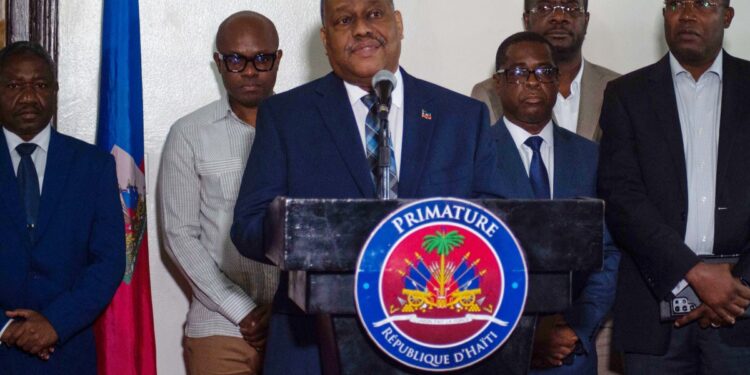 (FILES) Haiti's Prime Minister Garry Conille speaks to the press on his return to Port-au-Prince, July 6, 2024, after travelling to the US and meeting with the UN Security Council. (Photo by Clarens SIFFROY / AFP)