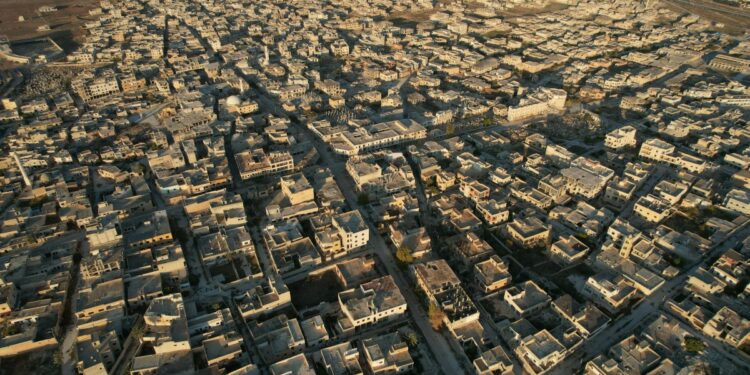 An aerial view shows the town of Saraqib in the eastern part of the Idlib province in northwestern Syria on December 1, 2024. - Government forces lost control of Syria's second city Aleppo on on December 1, for the first time since the country's civil conflict began, the Syrian Observatory for Human Rights said, after a lightning offensive dealt a severe blow to President Bashar al-Assad. (Photo by Aaref WATAD / AFP)