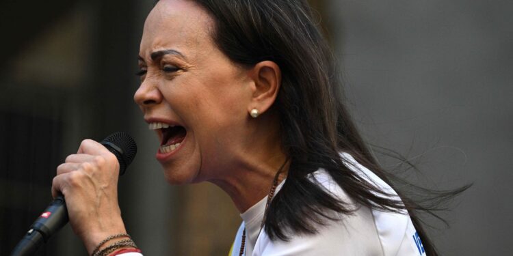 Venezuelan opposition leader Maria Corina Machado gives a speech during a protest called by the opposition on the eve of the presidential inauguration, in Caracas on January 9, 2025. Venezuela is on tenterhooks facing demonstrations called by both the opposition and government supporters. Machado emerged from hiding to lead protests in Caracas against the swearing-in of Nicolas Maduro for a highly controversial third term as president. (Photo by Federico PARRA / AFP)