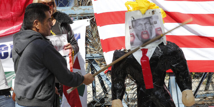 MEX297. CIUDAD DE MÉXICO (MÉXICO), 20/01/2025.- Una persona golpea un muñeco con la cara de Donald Trump durante una protesta este lunes, frente a la embajada de Estados Unidos en la Ciudad de México (México). Decenas de activistas se manifestaron en la capital mexicana para expresar su rechazo a las "abusivas e inhumanas" políticas antimigratorias y proteccionistas de Donald Trump, quien asumió un nuevo mandato presidencial en la Casa Blanca. EFE/ Mario Guzmán