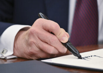 US President Donald Trump signs an executive order in the Oval Office of the White House in Washington, DC, on January 23, 2025. (Photo by ROBERTO SCHMIDT / AFP)