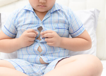 boy overweight. Tight shirt of pajamas, healthy concept